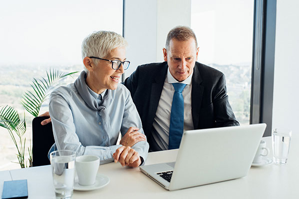 man and woman looking at laptop