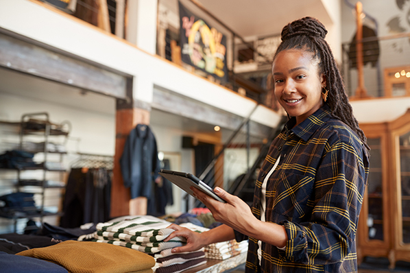 image of a young woman working in a clothing retail store