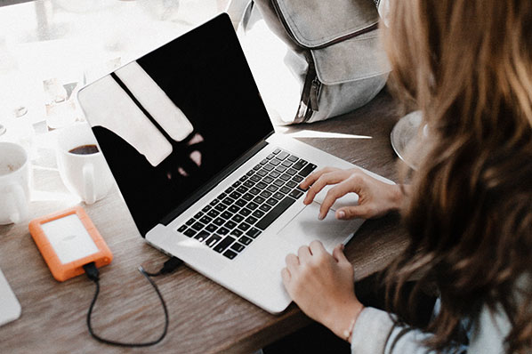 woman with laptop facing away from camera