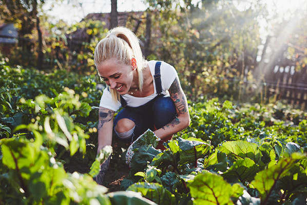 young woman in her backyard vegetable garden