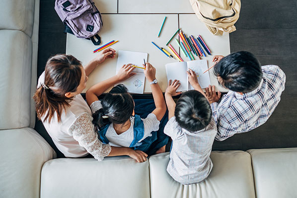 Young family drawing at a table