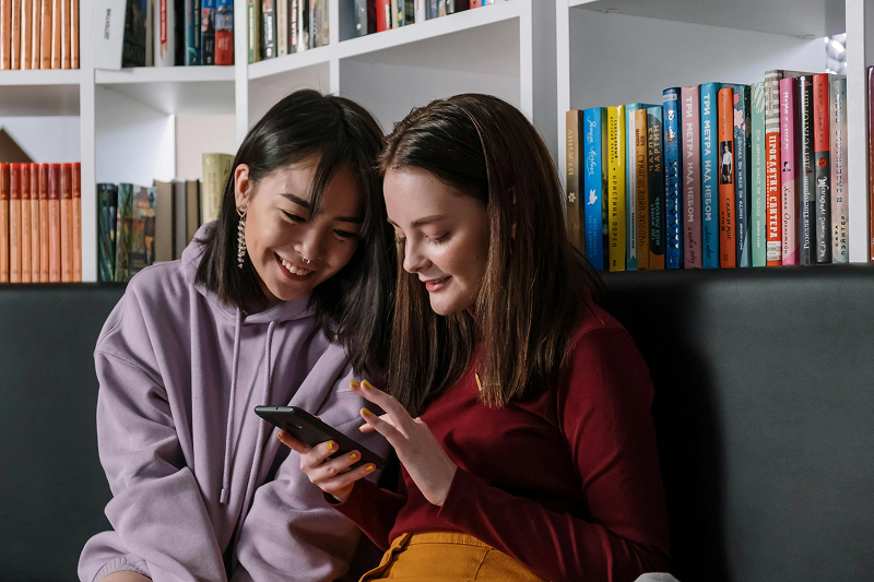 Two girls looking at a phone screen