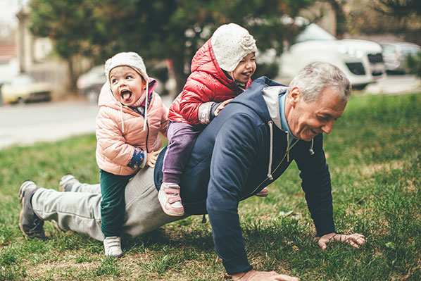 grandpa doing pushups with kids on his back