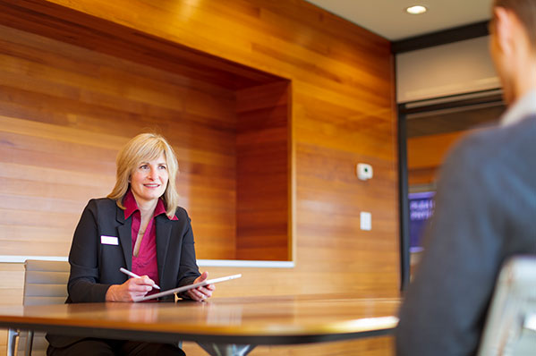 female advisor sitting at a table talking with a client