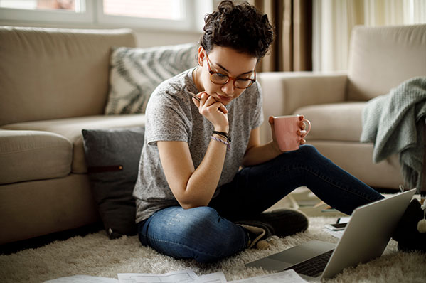 woman sitting on the floor with her laptop