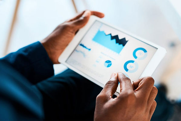 man holding tablet showing stock market performance.jpg