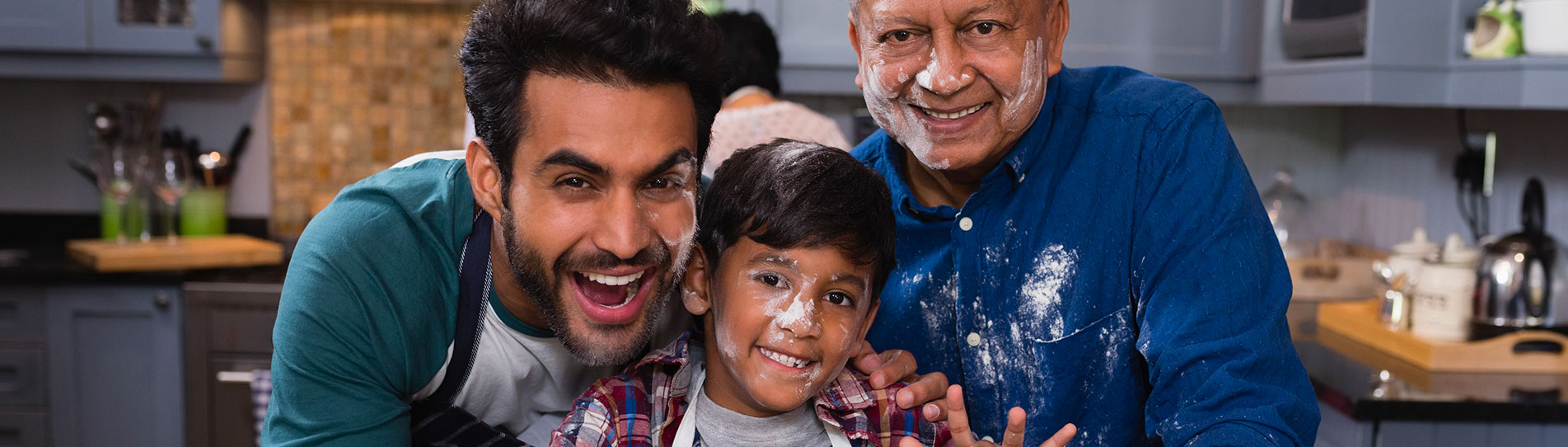 son, dad and grandpa baking in the kitchen