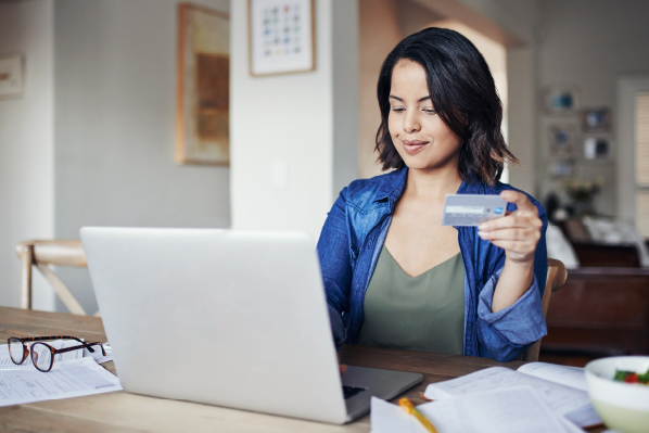 woman with laptop holding a debit card.jpg